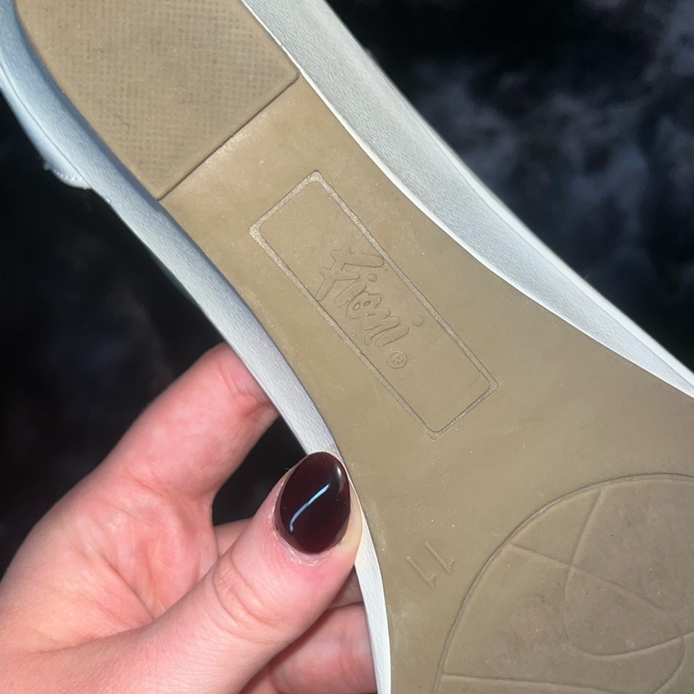 White close-toed wedges with straps and silver buckle.